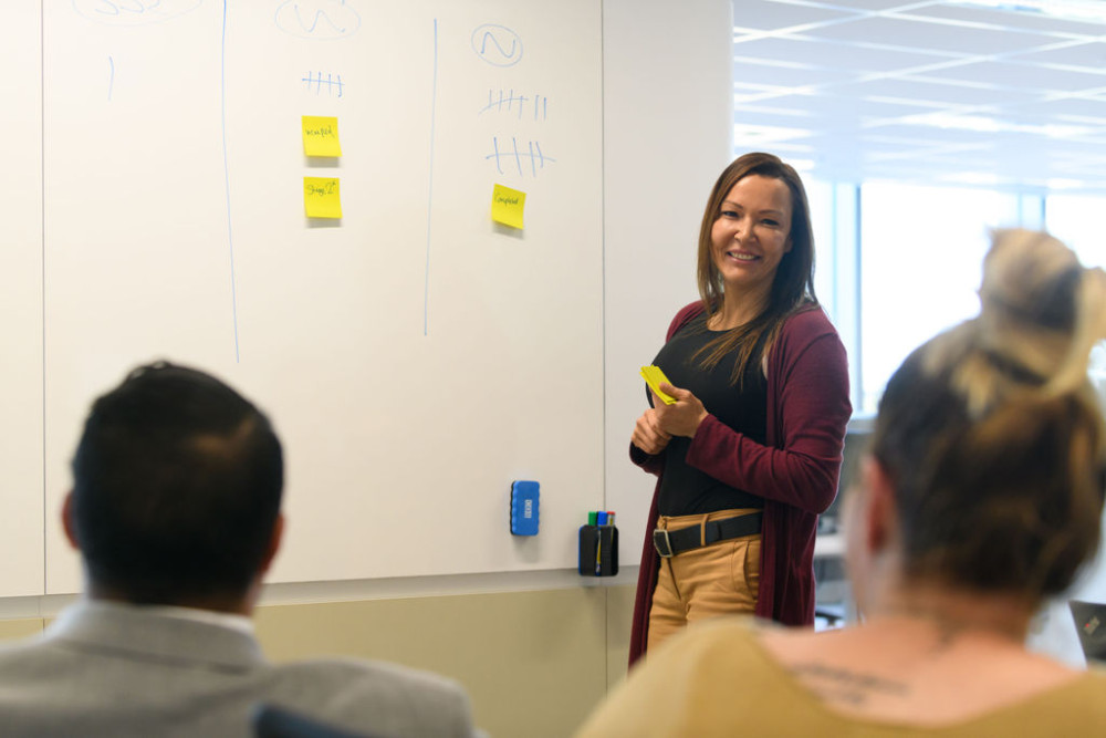 Aboriginal woman leading team meeting at Aboriginal Housing Office