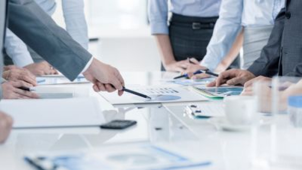 Senior executives reviewing work at a table