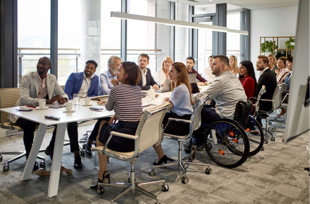 diverse team meeting with wheelchair user