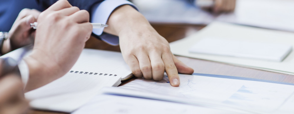 A man points at information in a document