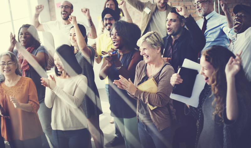 A group of people standing and cheering