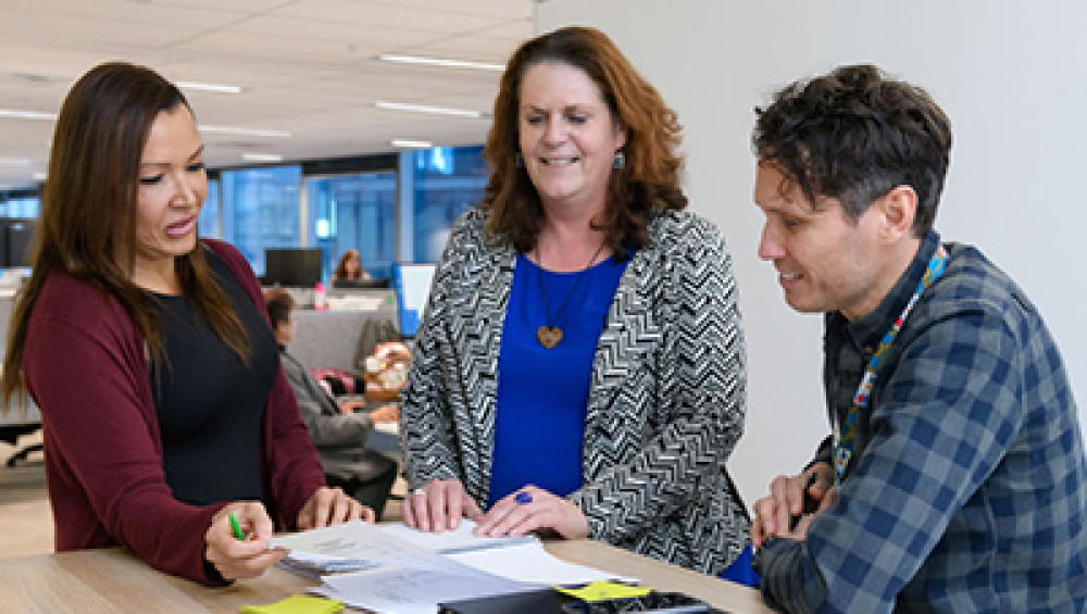 three work colleagues chatting at a table