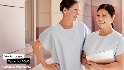 Two nurses standing next to each other, smiling