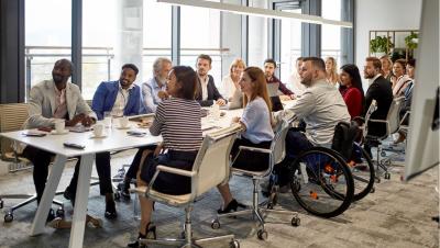 diverse team meeting with wheelchair user